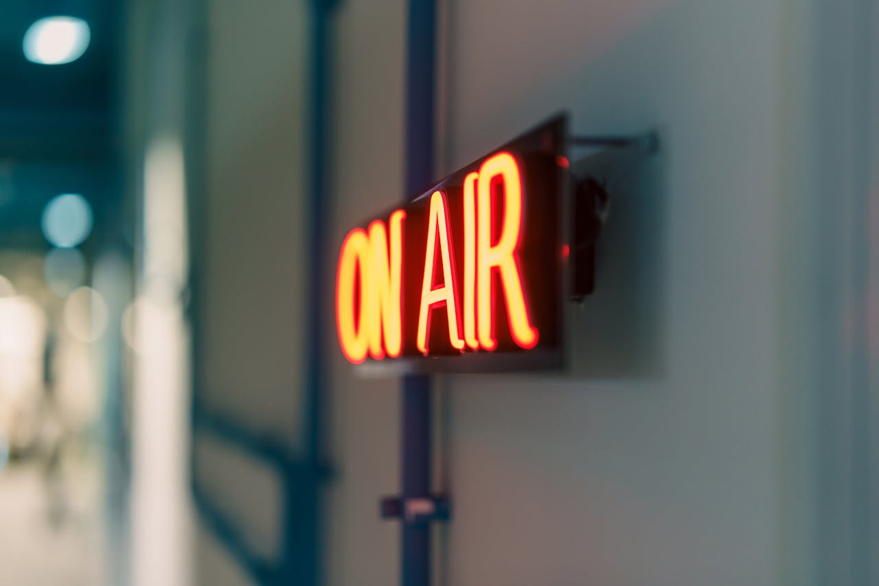 Bright red On Air neon sign captured indoors, ideal for media content.